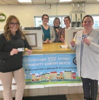 Northtown Banking Centers employees standing by Community Banking Month banner