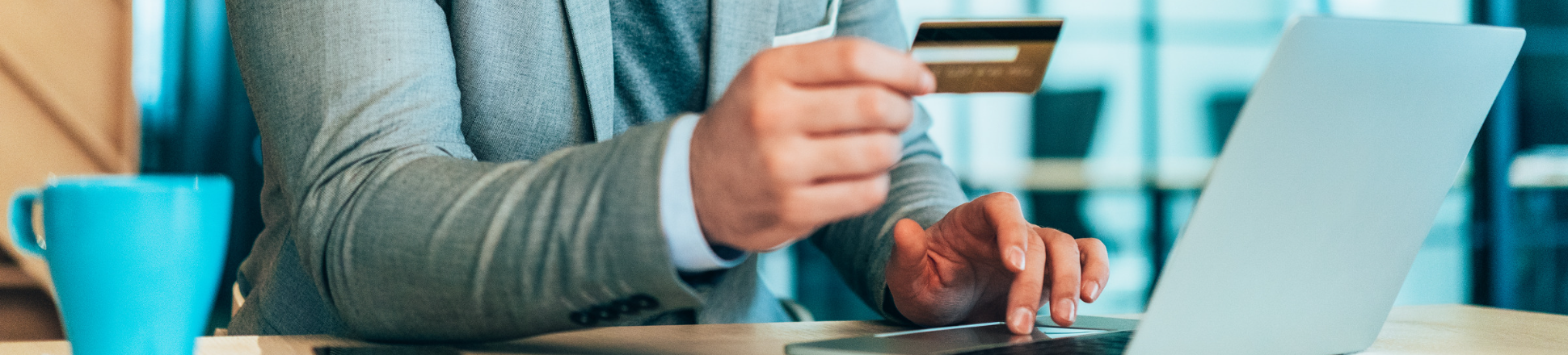 Business professional entering credit card information into laptop