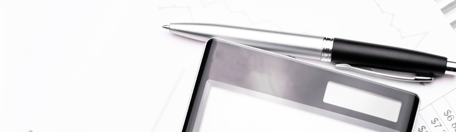 Calculator and pen on papers