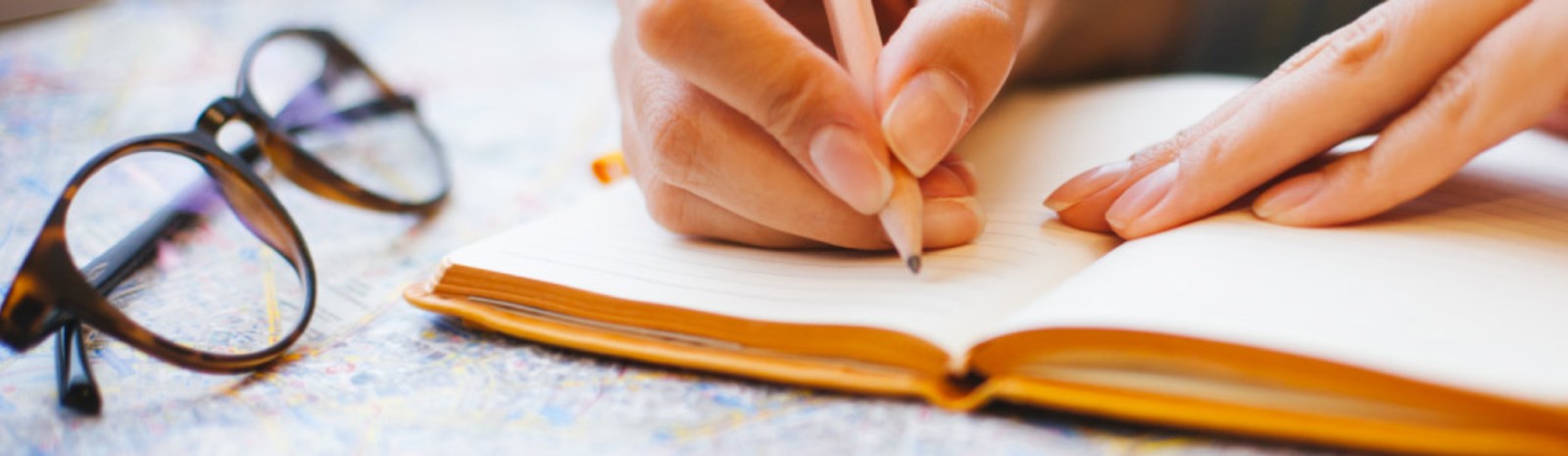 Person writing in a book